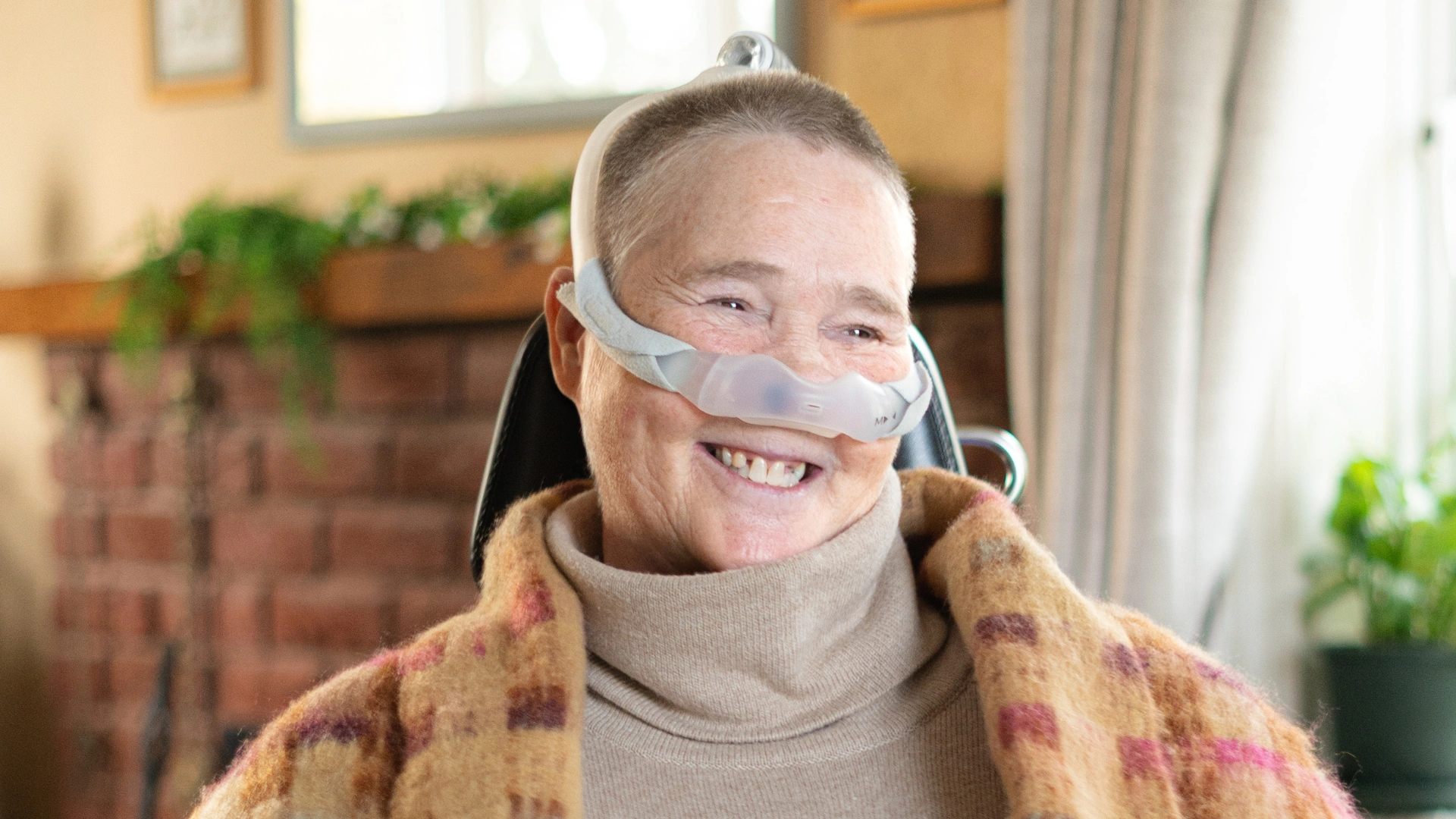 Marion smiling and showing the positive impact of her nurse-led complex care package at home provided by Komplex Care