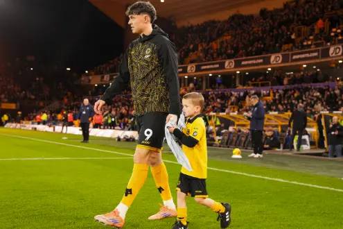 Felix with walking on the pitch with a Wolves player