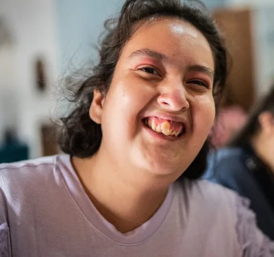Komplex Care client with learning disabilities smiling and enjoying a happy moment at hom